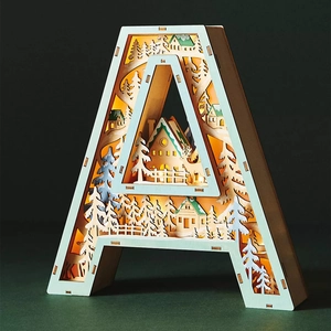 Macro view of multi-layer wooden letter A light with 3D forest scene and warm LED