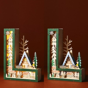 Detail of letter L wooden LED lamp showing winter village scene with snowy houses