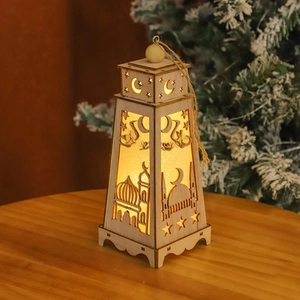 Close-up of wooden LED lantern with laser-cut mosque patterns on a rustic wood surface