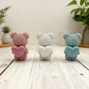 Close-up of resin bears with realistic crochet texture and shiny heart details