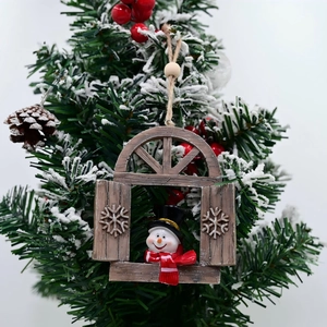 Detailed view of 3D snowman resin Christmas ornament hanging on a snowy tree branch