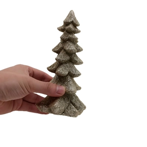 Miniature gold glitter Christmas tree ornament held by hand for tabletop decoration