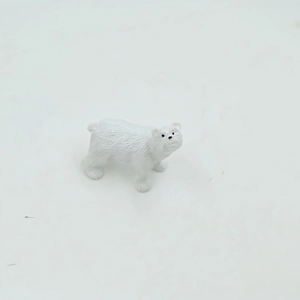 Detailed close-up of a miniature polar bear figurine with textured white resin fur detail