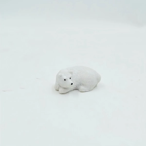 Macro detail of a white polar bear resin figurine in a resting pose for micro landscapes