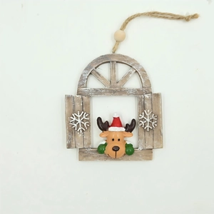 Detail of wooden Christmas window ornament featuring a 3D reindeer with red hat and snowflakes