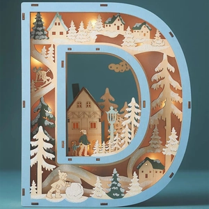 Detail of wooden letter D LED light featuring an intricate 3D winter snow scene craft