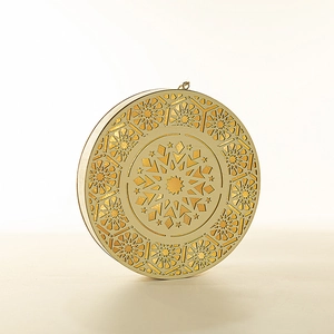 Golden round hanging lantern with geometric cut-out patterns and warm LED light detail