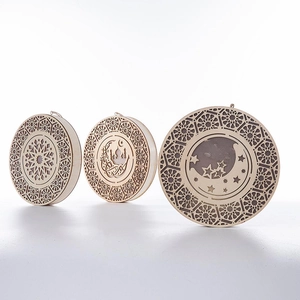 Detailed laser-cut wooden Ramadan ornaments featuring moon, stars and mosque patterns