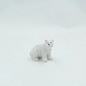 Detailed view of miniature polar bear figurine with realistic white fur texture