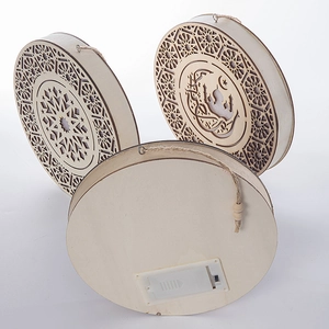 Front and back detail of laser-cut wooden LED star moon pendants with battery case