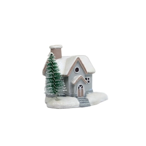 Miniature Christmas resin snow house with pine tree and glitter detail on white background