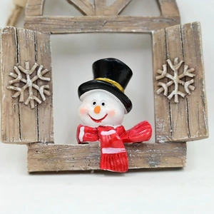 Christmas snowman ornament in rustic window frame with white snowflakes on white background