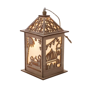 Close-up of wooden Muslim festive lantern featuring laser-cut mosque and warm LED light