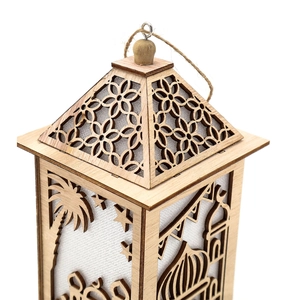 Close-up of laser-cut wooden Muslim lantern featuring palm tree and mosque silhouettes