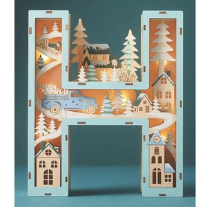 Detail of wooden letter H Christmas LED lamp with hollowed winter scene and warm lights