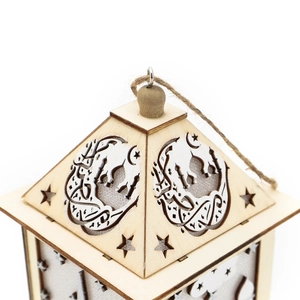 Detail of wooden Eid lantern with laser-cut mosque and crescent moon patterns