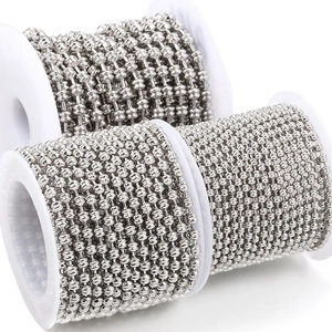 Close-up of polished stainless steel ball chains on spools for DIY jewelry making