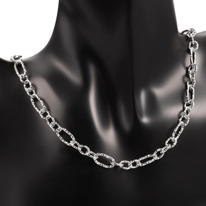 Detailed view of silver stainless steel cross chain with diamond-cut texture on neck mannequin