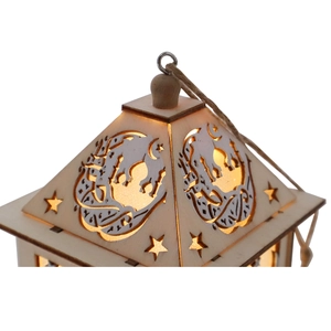 Detail view of wooden Muslim lantern top with cutout patterns and warm LED light