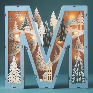 Macro view of letter M wooden LED lamp with warm glowing hollowed winter snow scene