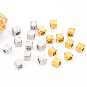 DIY jewelry beads made of stainless steel cubes with numbers in gold and silver finish