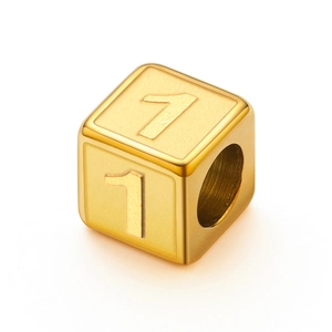 Detailed view of a gold-plated stainless steel cube bead with number 1 engraving
