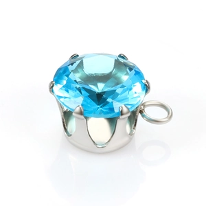 Macro shot of sky blue round cut gemstone with six-prong silver setting and side loop