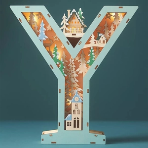 Detail of wooden letter Y LED light featuring a 3D laser-cut winter forest snow scene