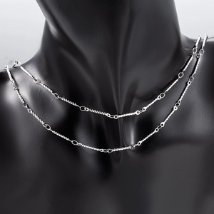 Detail of double-layered stainless steel twisted bar chain necklace on a black bust