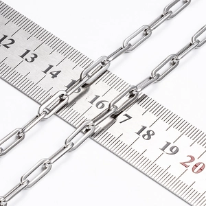 Detailed view of silver stainless steel paperclip chain links on a measuring ruler