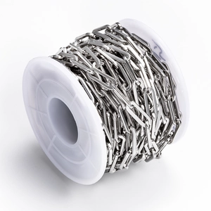 Close-up of polished stainless steel rectangular box chain links on a white spool