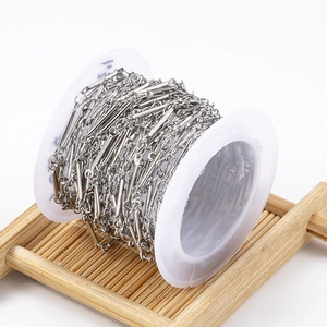 Polished stainless steel cylinder and loop DIY jewelry chain on a white spool