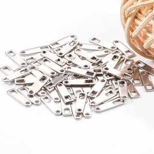 Macro shot of rectangular stainless steel logo tags with polished silver finish