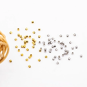 Golden and silver stainless steel crimp beads for DIY jewelry making on white background