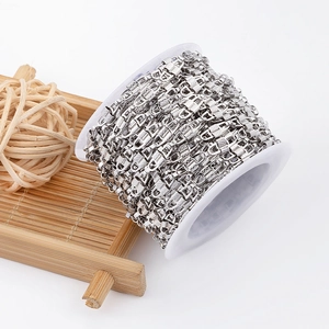 Polished silver stainless steel chain spool with intricate diamond-cut texture for DIY jewelry