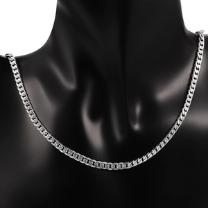 Macro detail of silver stainless steel Cuban chain showing textured link patterns
