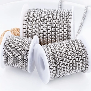Polished silver stainless steel box chains in three sizes on white spools for DIY jewelry