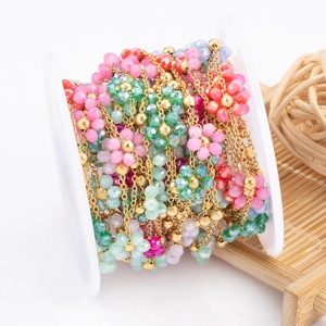 Colorful floral crystal beaded chain with gold metal links on a spool for DIY jewelry