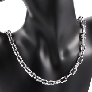 Detail shot of heavy stainless steel oval link chain with spiral textured thread wrap
