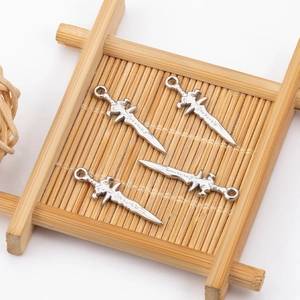 Detailed view of four fantasy-style silver stainless steel sword charms for DIY jewelry
