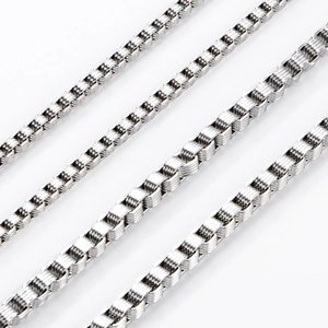 Macro view of polished stainless steel box chain showing intricate silver links