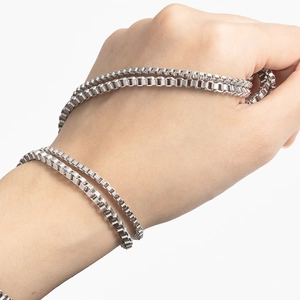 Detailed close-up of a silver vertical box chain with a high-polished metallic finish