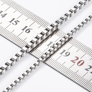 Detail of 3mm stainless steel box chain measured on ruler showing precise link width