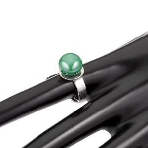 Detailed view of an adjustable silver ring featuring a large polished emerald green bead