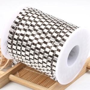 Roll of silver stainless steel box chain for DIY jewelry making on white plastic spool