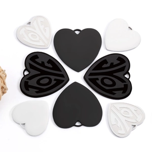 Detailed arrangement of heart-shaped LOVE pendants in polished silver, black, and white finish