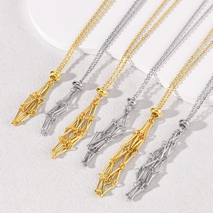 Macro view of geometric hollow tassels on adjustable stainless steel cage necklaces