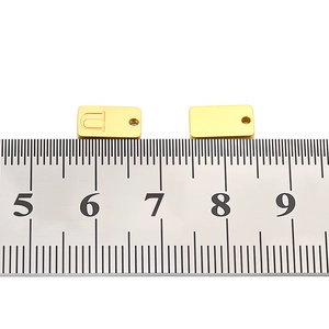 Macro shot of rectangular stainless steel letter U pendant for DIY jewelry making