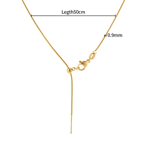 Detailed view of 0.9mm gold snake chain with lobster clasp and adjustable bead