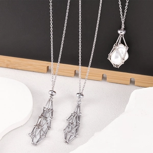 Adjustable stainless steel mesh cage necklace for crystals shown on a modern display